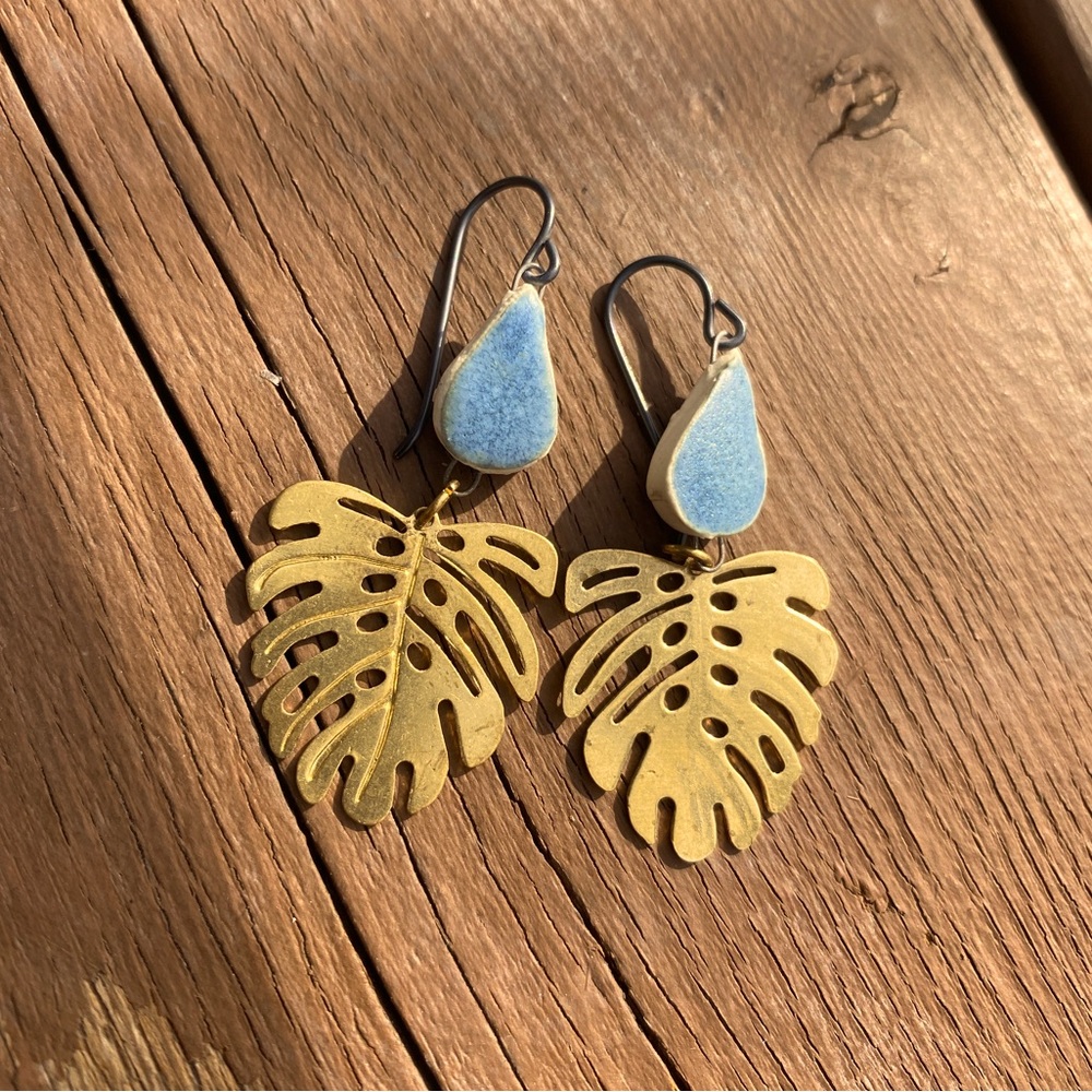 gold plant leaf earrings with teal stone